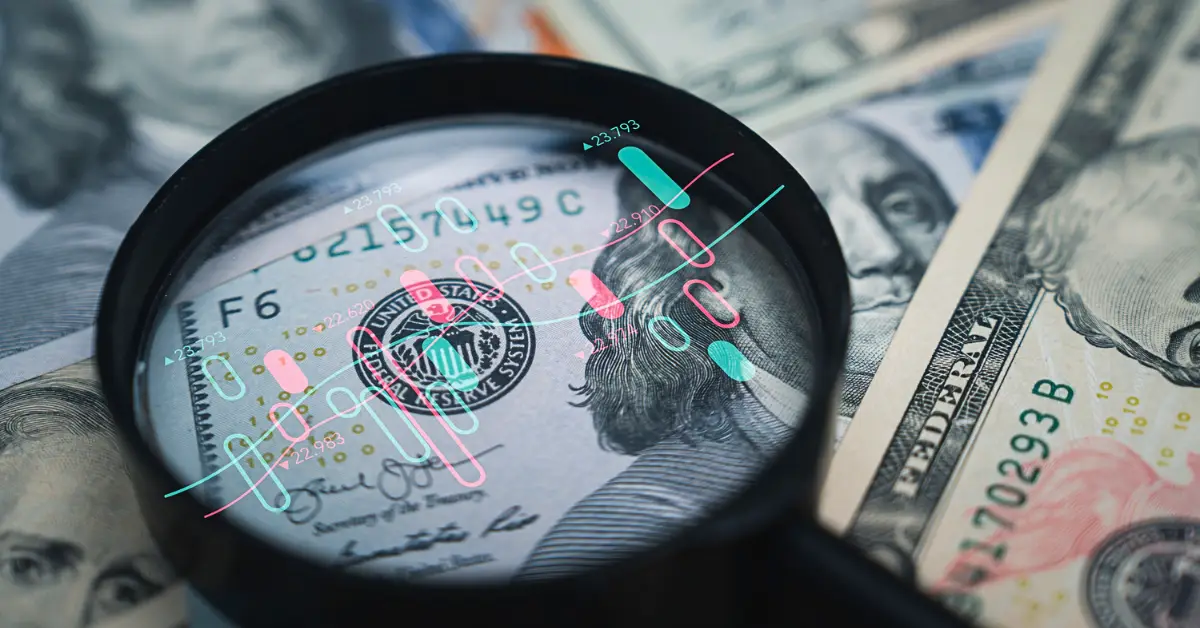 hundred dollar bill with magnifying glass and stock pattern - etfs vs mutual funds