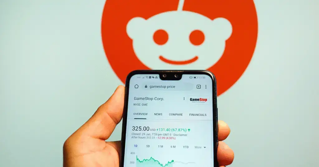 GameStop (NYSE:GME) stock price with Reddit logo in the background