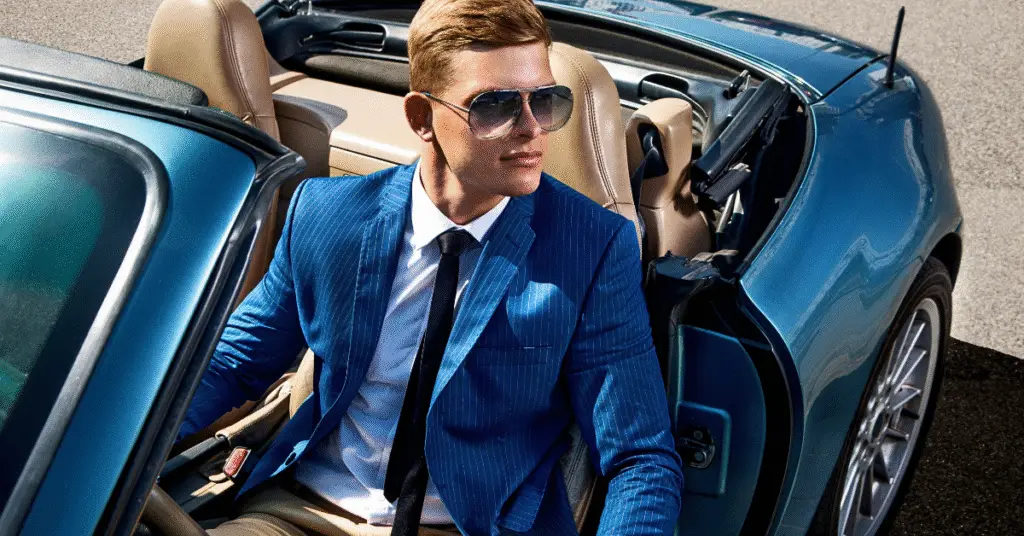 Successful man in a suit inside a sports car - how to make a comeback in your 30's.