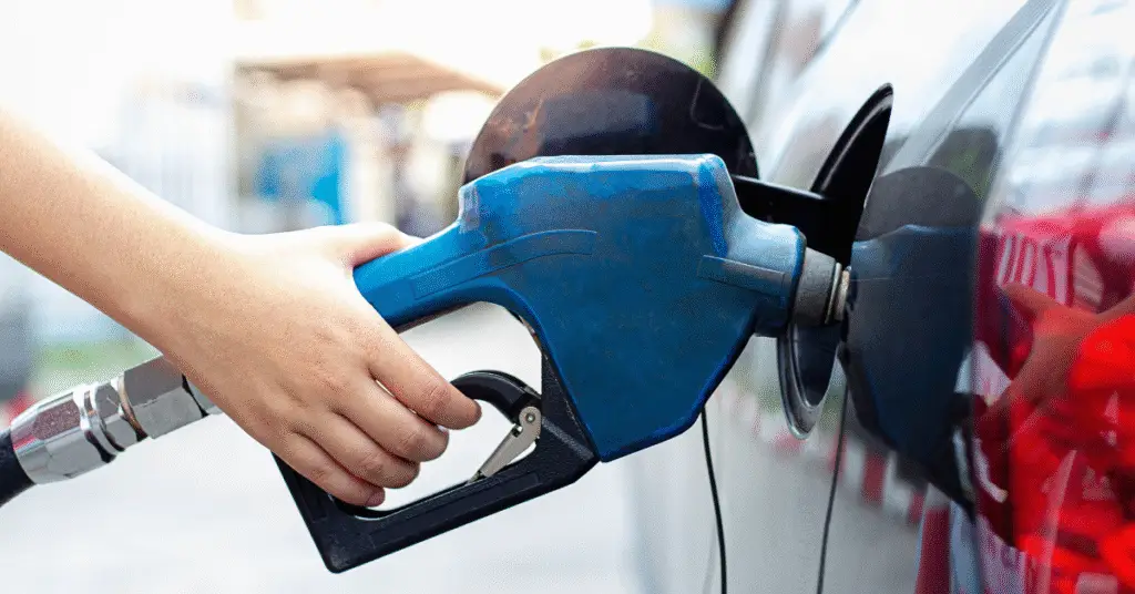 A person putting gas in their vehicle - why Economics matters